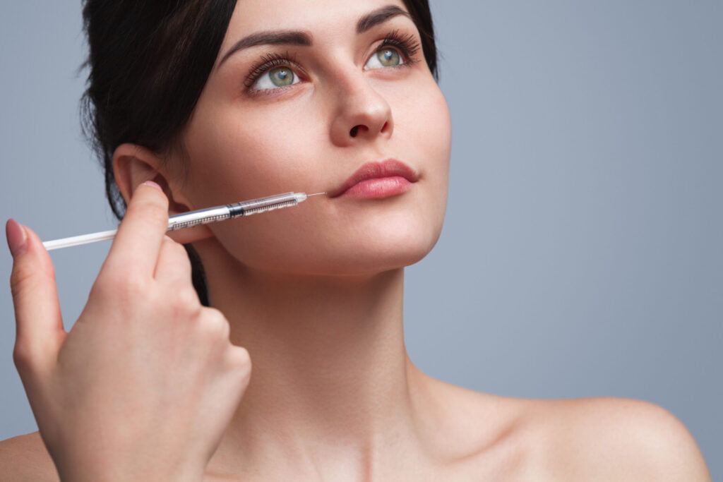 Woman receiving Botox injection for wrinkle reduction and facial enhancement.