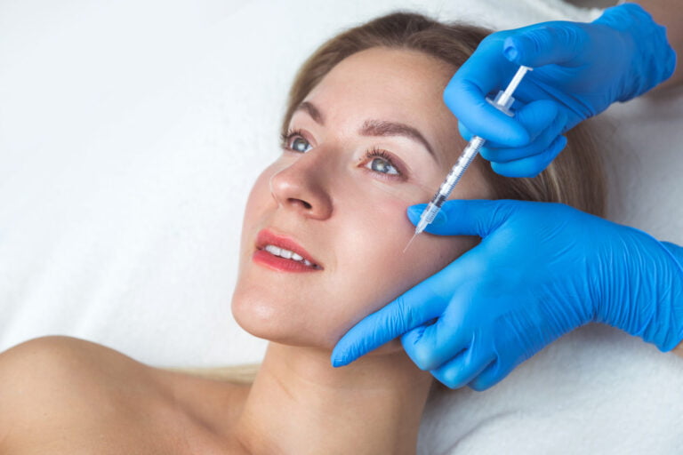 Woman receiving facial injections for rejuvenation and cosmetic procedure.