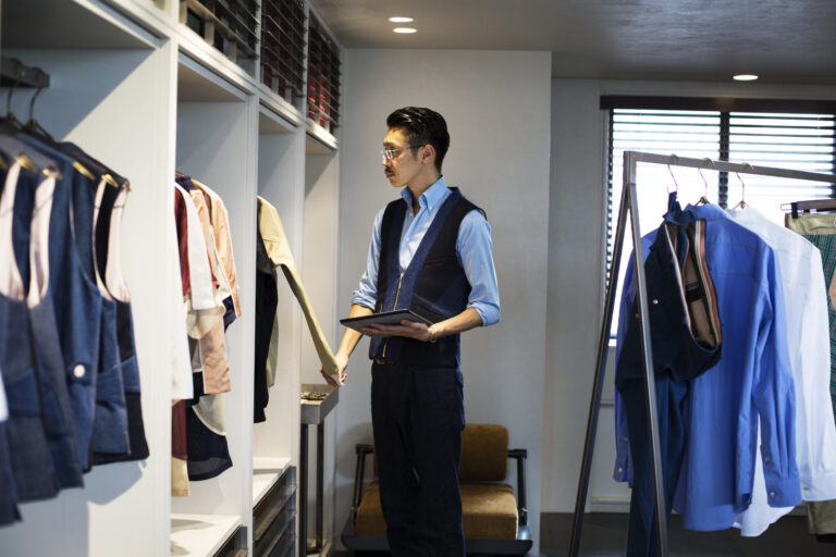 Man examining clothing in store, wardrobe update guide