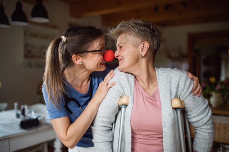 Healthcare worker and elderly woman connecting, caregiving and design in healthcare.